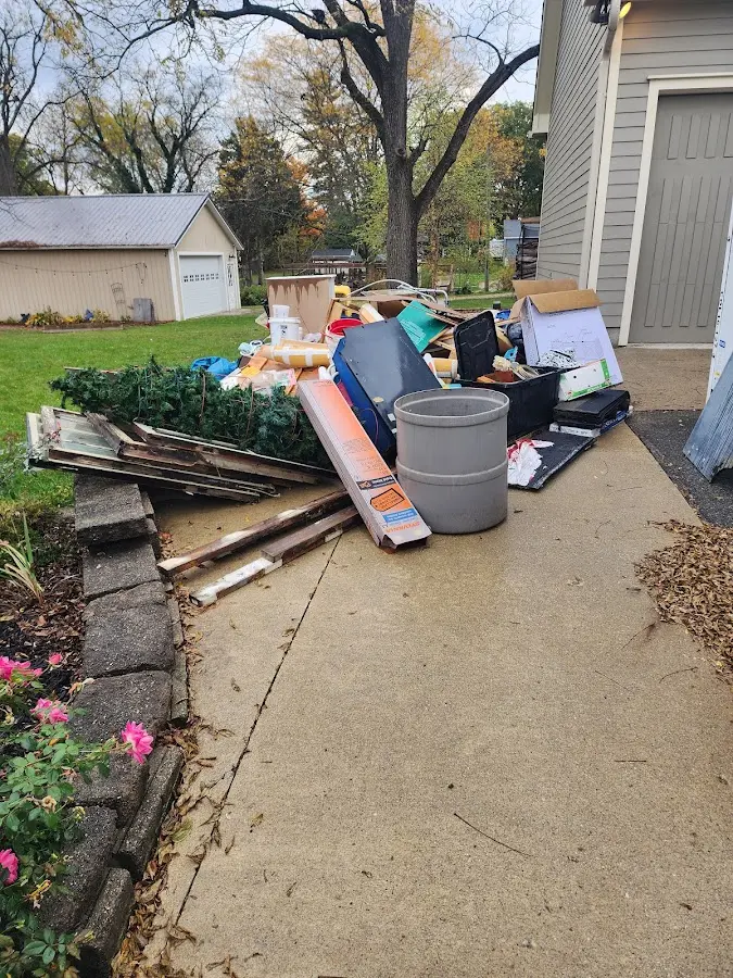Dumpster being loaded with debris for Commercial Dumpster Rental in Beekmantown